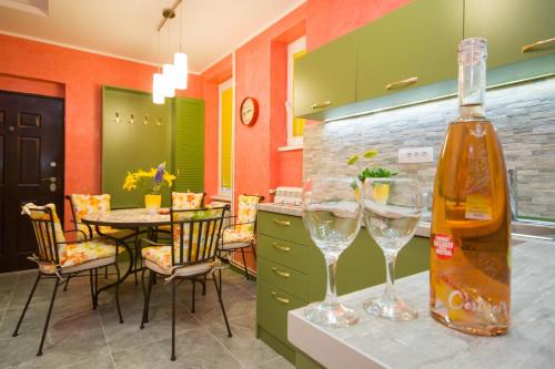 a kitchen with a table and two wine glasses at Romance in Belgrade