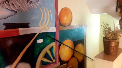 a painting of a painting of fruit on a wall at Casa Rural Barracas in Barracas
