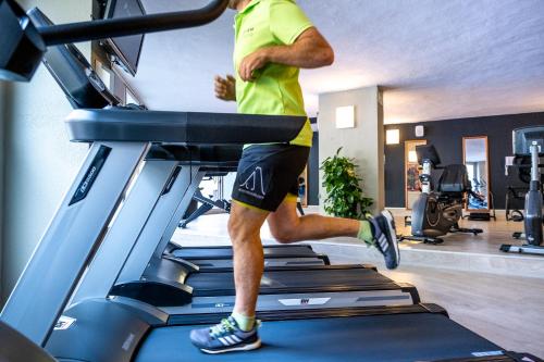 a man running on a treadmill in a gym at ARTIEM Audax - Adults Only in Cala Galdana