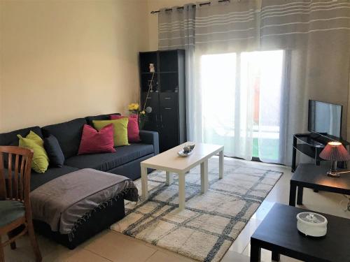 a living room with a couch and a table at Kyklades Resort & Spa in Paralimni