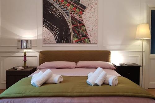 a bedroom with a bed with two pillows on it at A casa di Juno in Rome