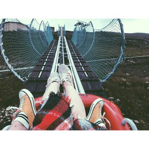 a person laying on a hammock on a zip line at villa in mountains in Bakuriani
