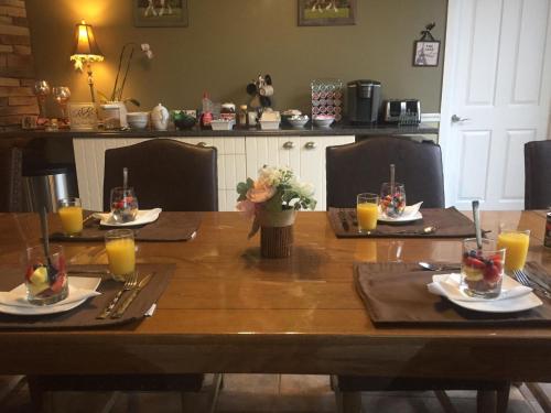a wooden table with plates and glasses of orange juice at Rock Pointe Ranch in Floral City