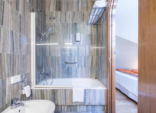 a bathroom with a shower and a sink and a tub at La Casa del Patrón in Murguía