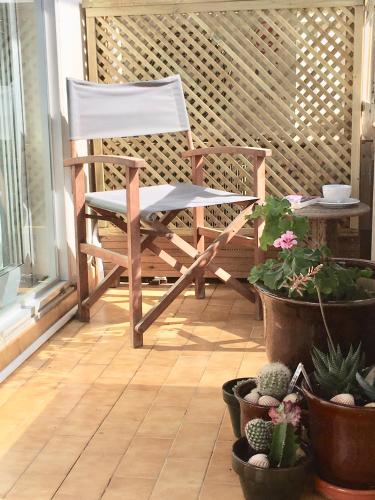 a rocking chair sitting on a porch with plants at Admirals Suite, Gibraltar in Gibraltar