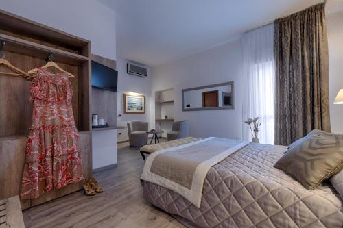 En eller flere senger på et rom på Hotel Rombino