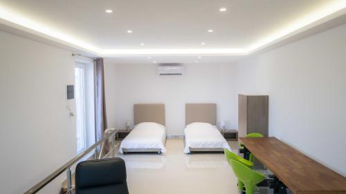 a hospital room with two beds and a table at Heraklion Airport Family Lux Apartment in Heraklio