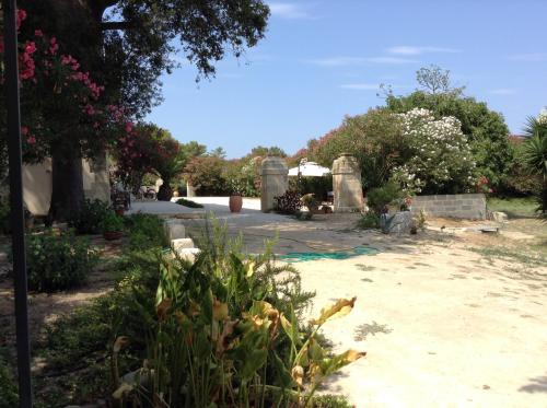 a garden with trees and flowers in a yard at Masseria Specchiulla in Otranto