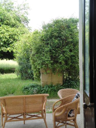 two wicker chairs sitting on a porch at Masseria Specchiulla in Otranto