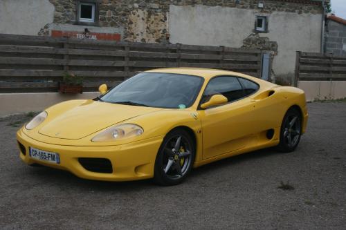a yellow car parked in a parking lot at LES GALAINES in Abzac