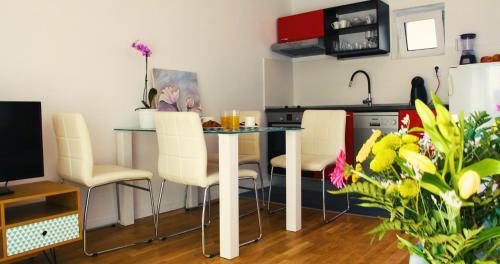 a kitchen with a table and chairs in a room at Apartments Beautiful View in Omiš