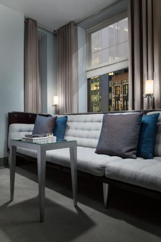 a living room with a white couch and a table at Royalton New York in New York