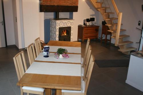a dining room with a table and a fireplace at LES GALAINES in Abzac