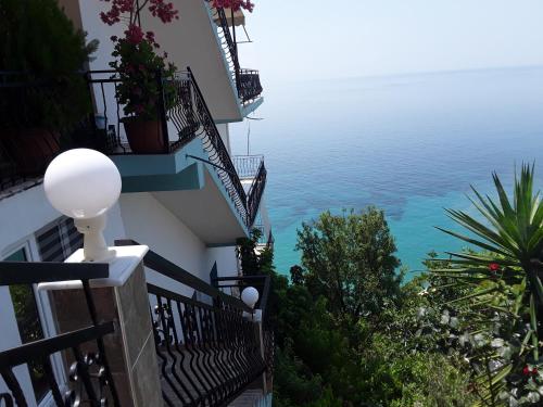a view of the ocean from the balcony of a building at Odhisea Hotel Restaurant in Qeparo