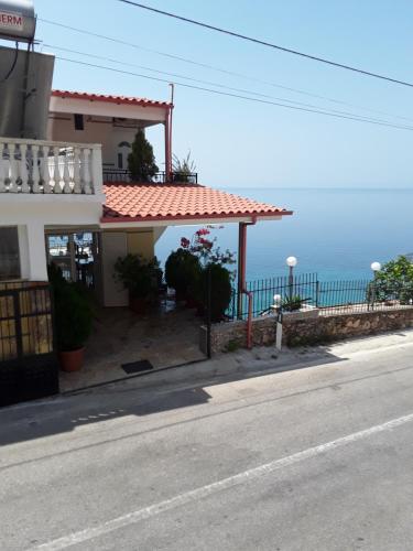 a building on the side of a road with the ocean at Odhisea Hotel Restaurant in Qeparo