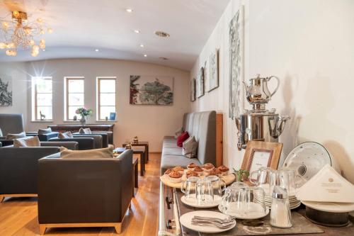 a living room with a table with plates of food at Hotel Walchseer Hof in Walchsee