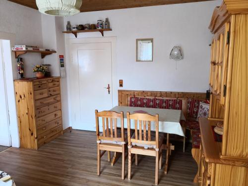 a kitchen with a table and chairs in a room at Ferienwohnung Central in Bad Steben