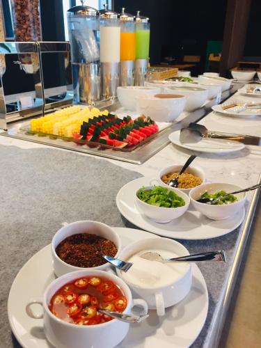 a buffet with bowls of food on a table at The Gallery Hotel Nai Harn in Nai Harn Beach