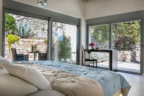 A bed or beds in a room at Aloni Villa - Contemporary Villa with Private Pool & Sea Views, Fiskardo