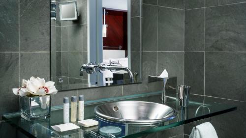 a bathroom with a sink and a mirror at Royalton New York in New York