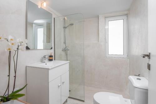a bathroom with a shower and a sink and a toilet at City apartment in Rhodes Town