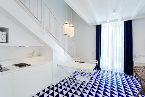 a kitchen with a blue and white tiled floor at Maison Blu - Intimate GuestHouse in Sorrento