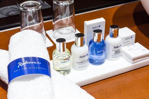 a group of bottles of toiletries on a table at Radisson Blu Hotel Lisbon in Lisbon