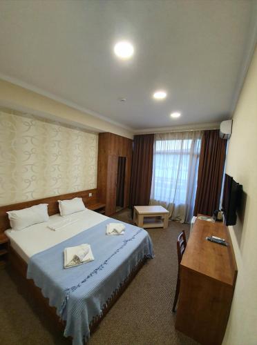 a hotel room with a bed and a desk at 5 Rooms near 300 Aragveli metro station in Tbilisi City