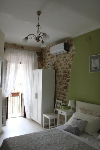 a bedroom with a bed and a green wall at Il viandante in Sulmona