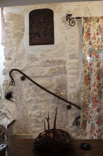 a lamp on a table next to a stone wall at Il viandante in Sulmona