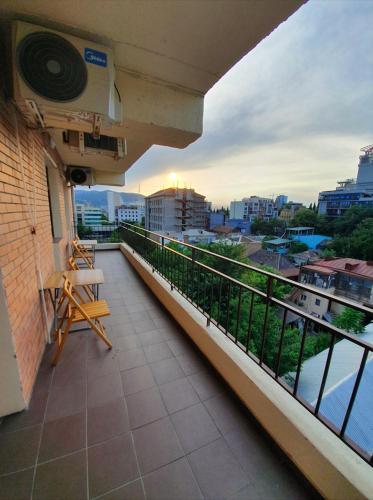 a balcony of a building with a view of a city at 5 Rooms near 300 Aragveli metro station in Tbilisi City