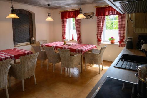 a dining room with a red table and chairs at Villa Jana in Janske Lazne