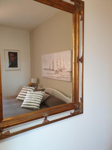 a mirror hanging on a wall in a room at Appartamenti Sole 1 in Alghero