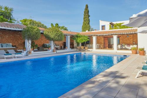 a swimming pool in front of a house at Bab el Oued Villa Ibiza in Puig D’en Valls