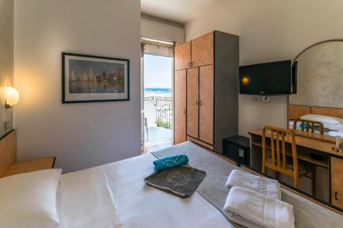 a hotel room with a bed and a window at Hotel Albatros in Rimini