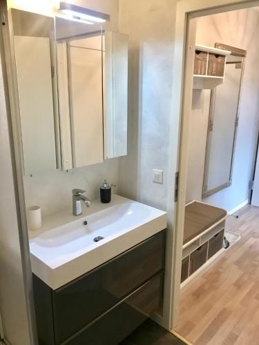 a bathroom with a sink and a mirror at Schöne Bergsicht in Hahnenklee-Bockswiese