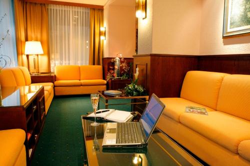 a living room with a laptop on a glass table at Elite in Lausanne