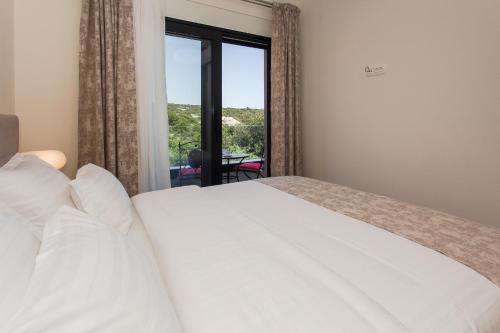 a bedroom with a bed and a window with a view at View Villas Collection in Vinišće