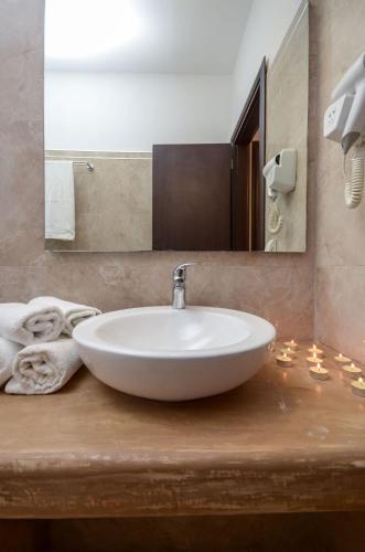 a bathroom with a white sink and a mirror at Naxos Luxury Villas in Mikri Vigla