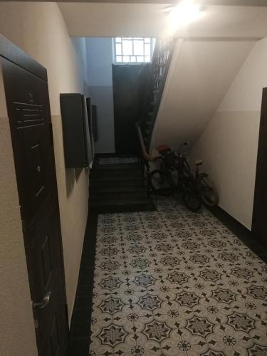 a hallway with a staircase and a bike on the floor at S7 Apartment in Rīga