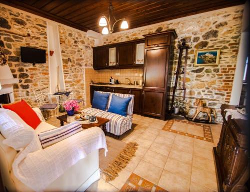 a living room with a couch and a table at Millers Guest House in Kalyves Poligirou