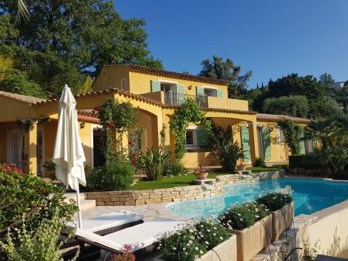 a villa with a swimming pool and a house at La Dolce Vita Opio in Opio
