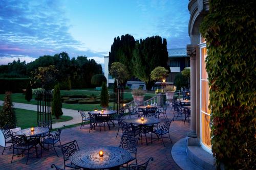 a patio with tables and chairs on a brick patio at Lyrath Estate in Kilkenny