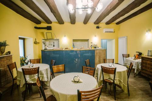 a restaurant with tables and chairs and a kitchen at Mariam R in Tbilisi City