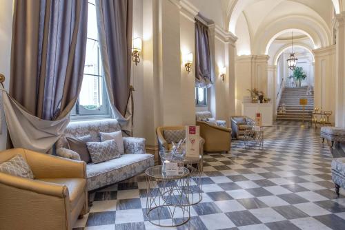 a living room with a couch and chairs and a checkered floor at Donna Camilla Savelli - VRetreats in Rome