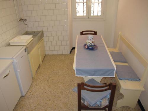 a kitchen with a table and chairs with a plate on it at CASA ROSSA in Borgomaro