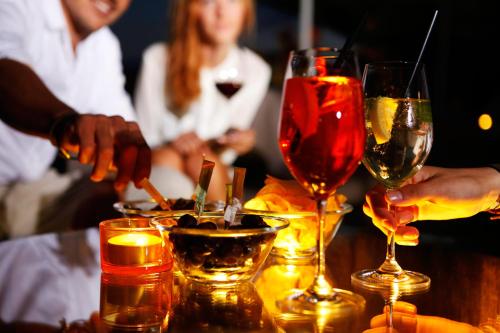 a group of people sitting at a table with wine glasses at Hotel Raffl in Bolzano