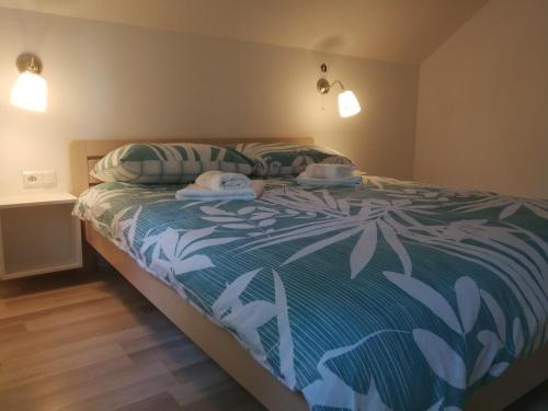 a bedroom with a bed with two towels on it at New apartment near Plitvice lakes in Smoljanac