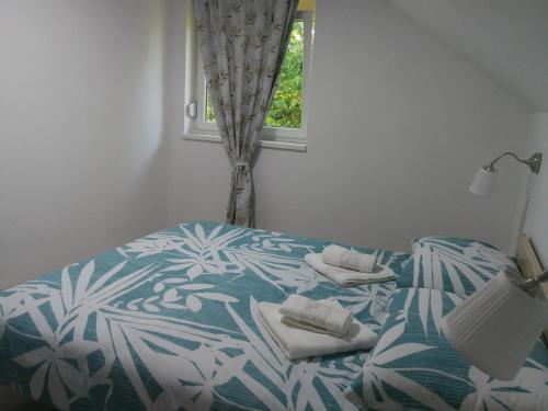 a bedroom with a bed with towels on it at New apartment near Plitvice lakes in Smoljanac