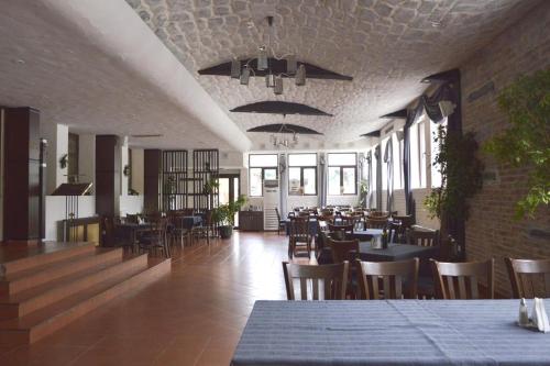 a restaurant with tables and chairs in a room at VIVA Flora apartment 607A in Borovets